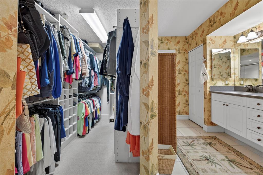 4670 Links Village Drive, Unit D506 Ponce Inlet, FL 32127 - Photo 26 of 60 a view of walk in closet with clothes and shoes