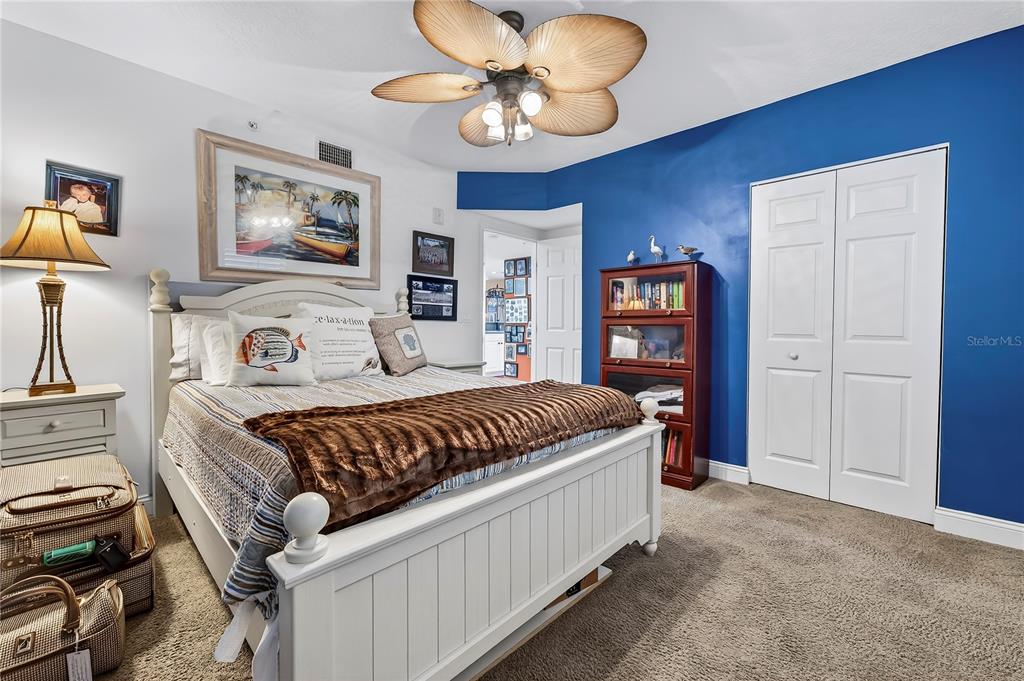 4670 Links Village Drive, Unit D506 Ponce Inlet, FL 32127 - Photo 29 of 60 a bedroom with a large bed and a chandelier