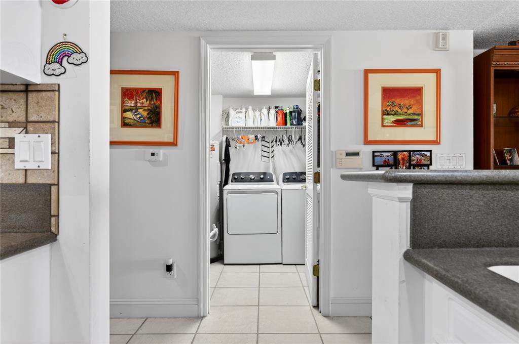 4670 Links Village Drive, Unit D506 Ponce Inlet, FL 32127 - Photo 32 of 60 a kitchen with stainless steel appliances granite countertop a refrigerator and a sink