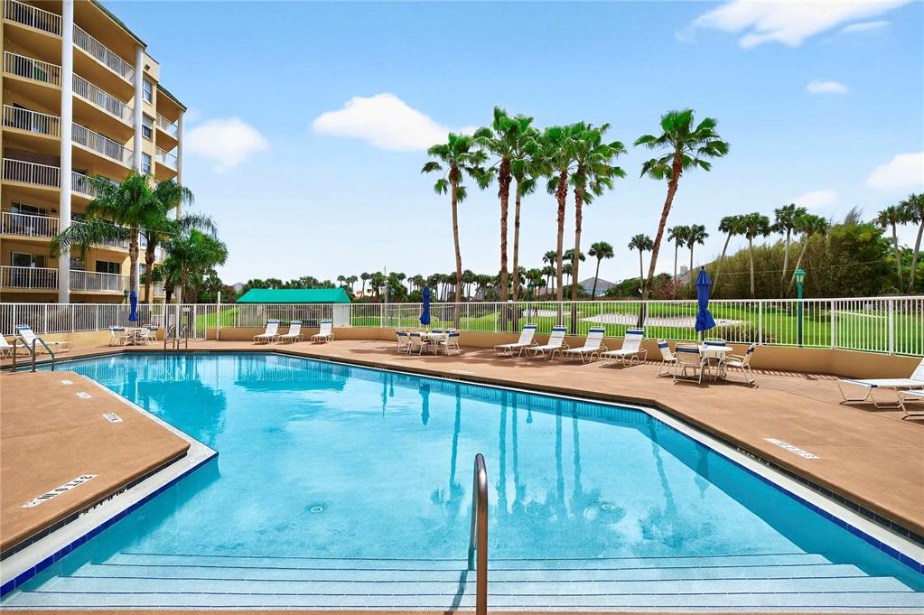 4670 Links Village Drive, Unit D506 Ponce Inlet, FL 32127 - Photo 43 of 60 a view of swimming pool with outdoor seating and yard in the back