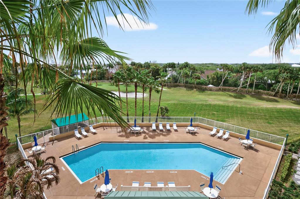 4670 Links Village Drive, Unit D506 Ponce Inlet, FL 32127 - Photo 46 of 60 a view of a swimming pool with a table and chairs