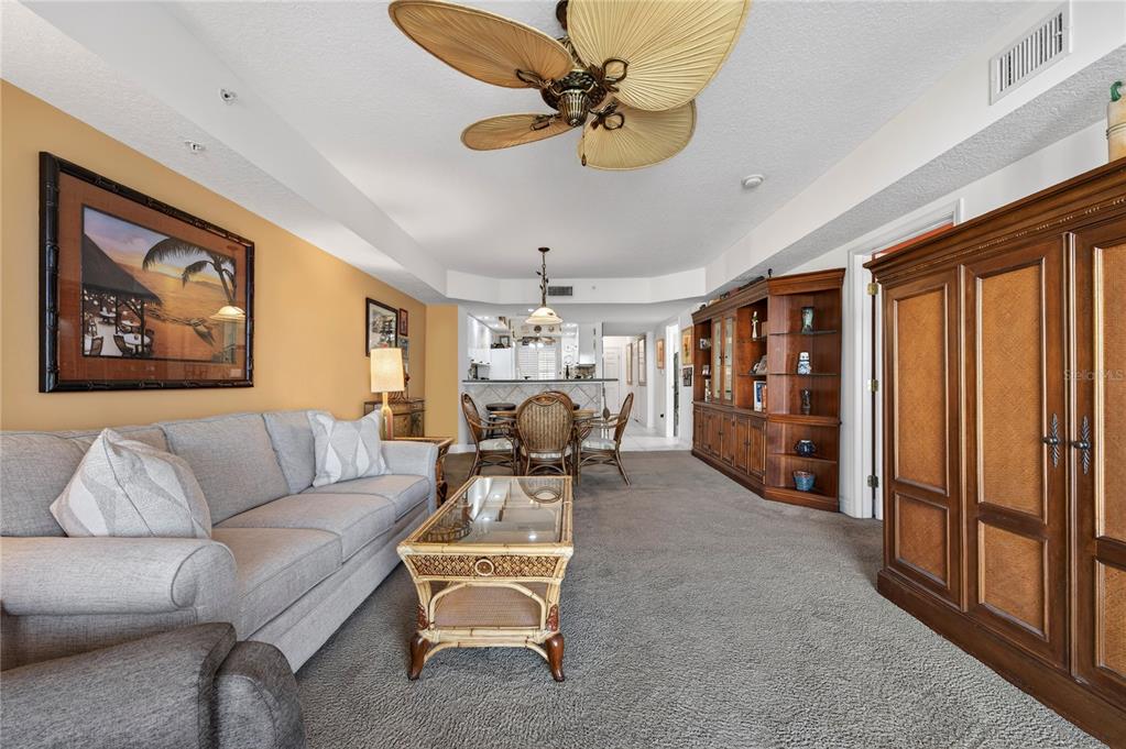4670 Links Village Drive, Unit D506 Ponce Inlet, FL 32127 - Photo 5 of 60 a living room with furniture ceiling fan and a rug