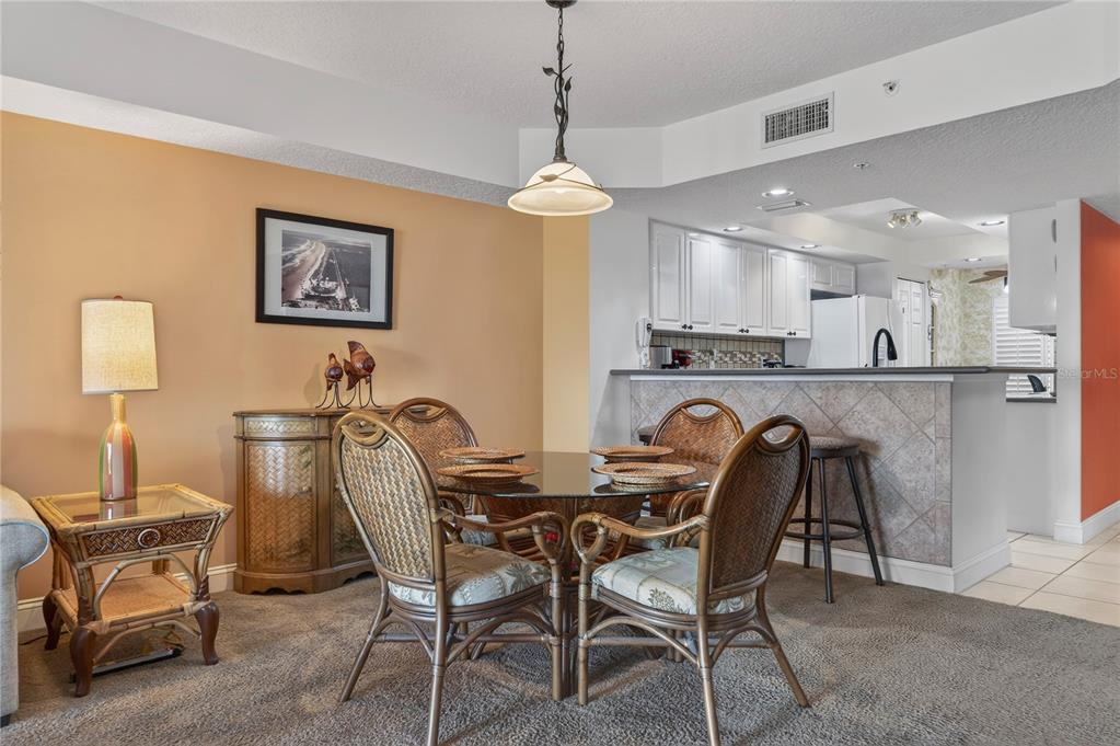 4670 Links Village Drive, Unit D506 Ponce Inlet, FL 32127 - Photo 10 of 60 a view of a dining room with furniture and a chandelier