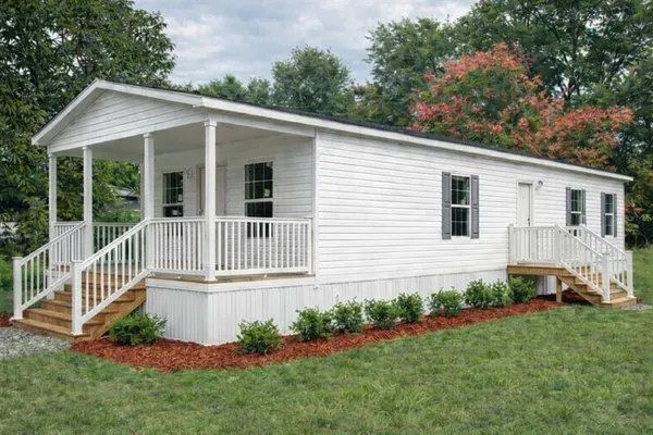 a view of a house with a yard and garden