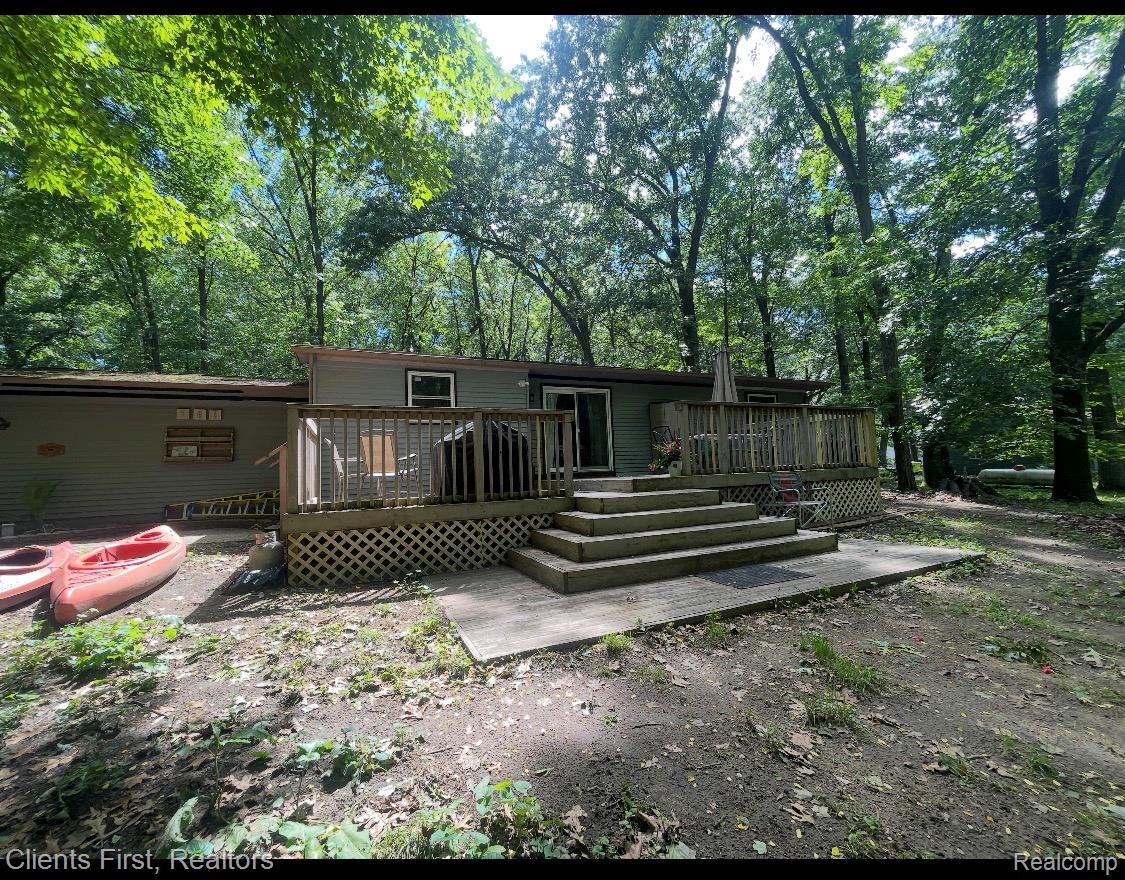 5844 Crandall Road Howell, MI 48855 - Photo 49 of 52 Expansive outdoor deck with lattice skirting and wood railings