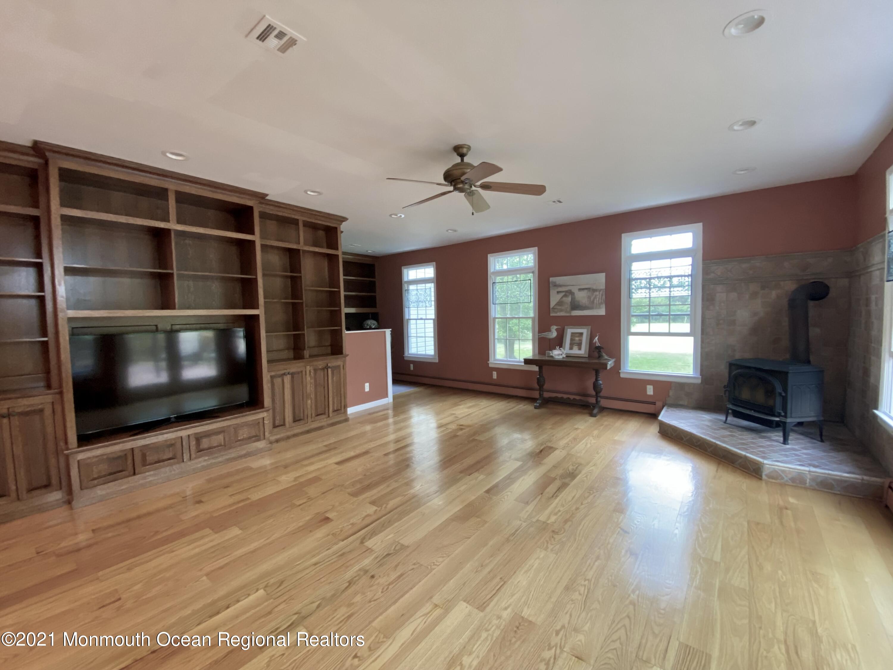 390 Cobain Road Jackson, NJ 08527 - Photo 14 of 53 a view of an empty room with a fireplace and a window