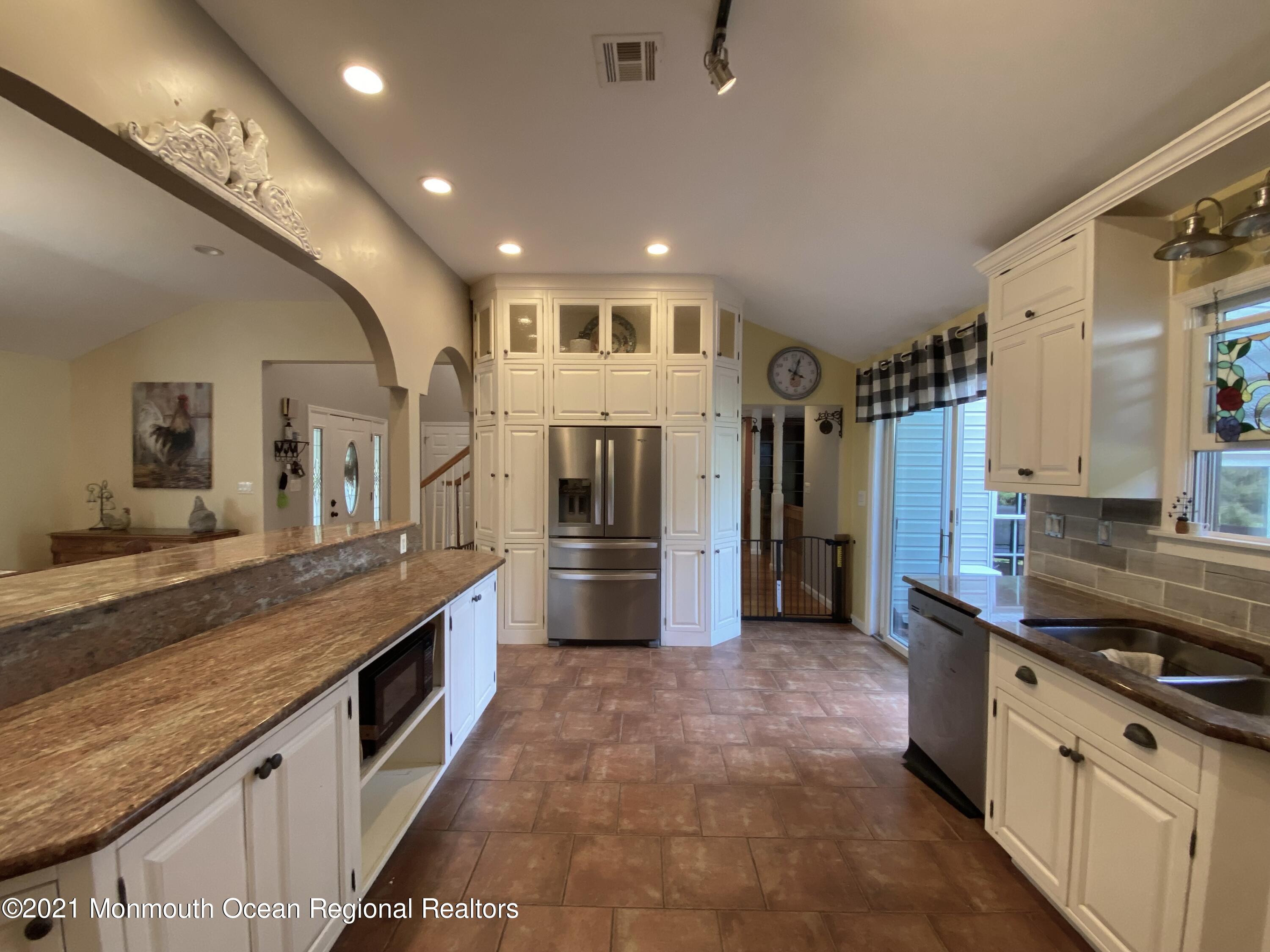 390 Cobain Road Jackson, NJ 08527 - Photo 8 of 53 a large kitchen with kitchen island a large counter top stainless steel appliances and cabinets