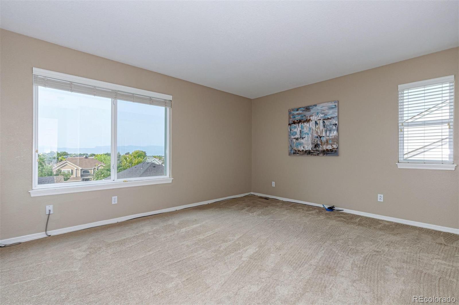 9939 Clyde Circle Highlands Ranch, CO 80129 - Photo 19 of 37 an empty room with windows