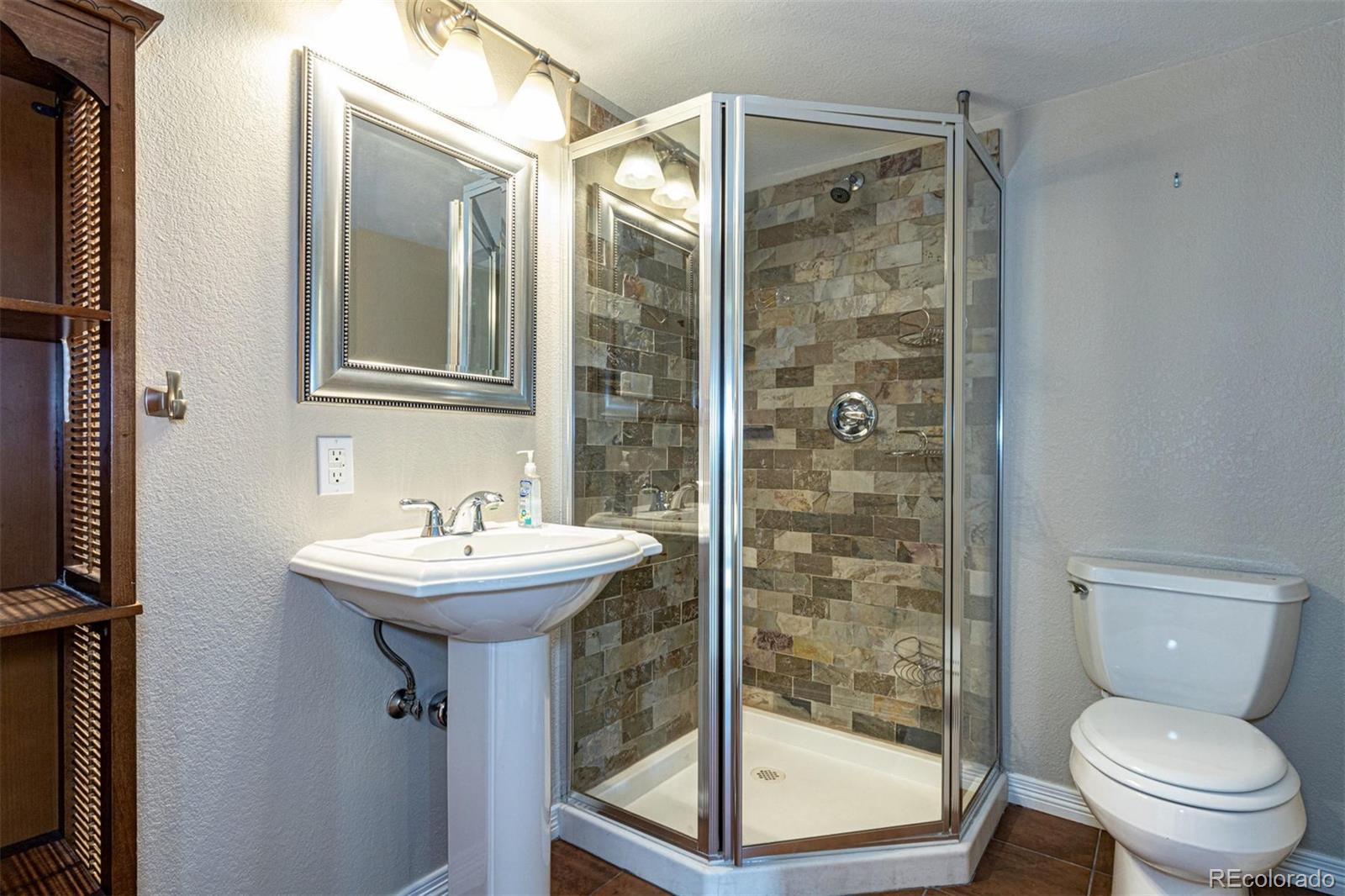 9939 Clyde Circle Highlands Ranch, CO 80129 - Photo 27 of 37 a bathroom with a sink toilet and shower