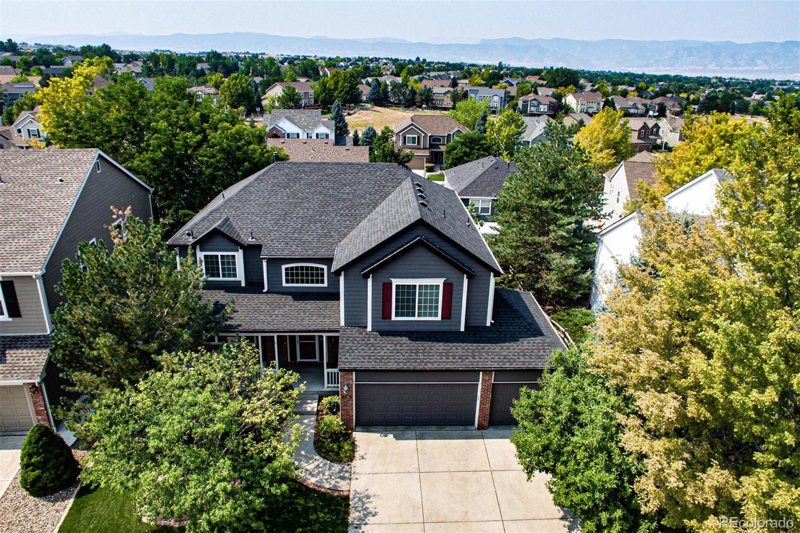 9939 Clyde Circle Highlands Ranch, CO 80129 - Photo 28 of 37 an aerial view of a house with a yard and potted plants