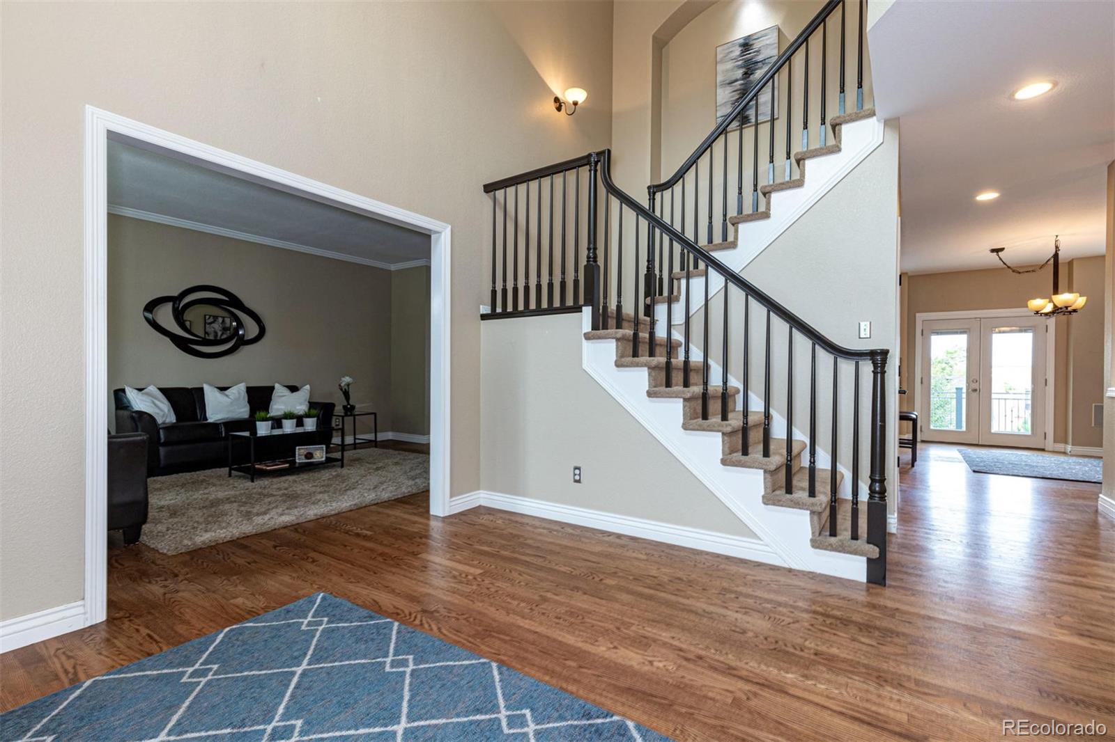 9939 Clyde Circle Highlands Ranch, CO 80129 - Photo 5 of 37 a view of a hallway with wooden floor and a hallway