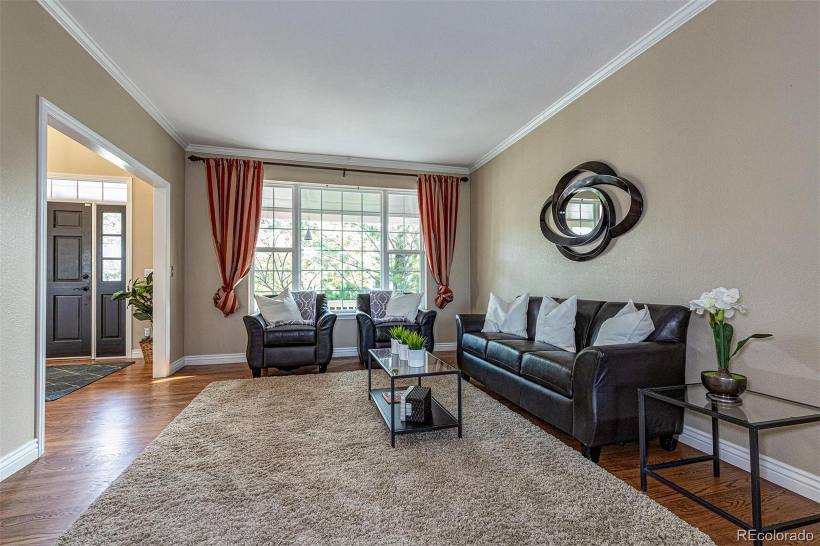 9939 Clyde Circle Highlands Ranch, CO 80129 - Photo 7 of 37 a living room with furniture and a large window