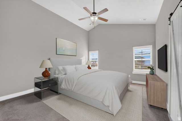 14714 South Bright Wood Road Herriman, UT 84096 - Photo 19 of 41 **Virtually Staged** Primary Bedroom featuring a barn door, multiple windows, ceiling fan, carpet floors, and high vaulted ceiling