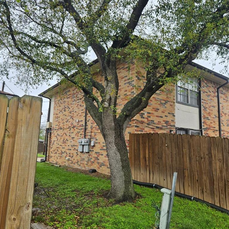 12 Trails Place, Unit AD Wylie, TX 75098 - Photo 12 of 40 a view of backyard with wooden fence and a large tree