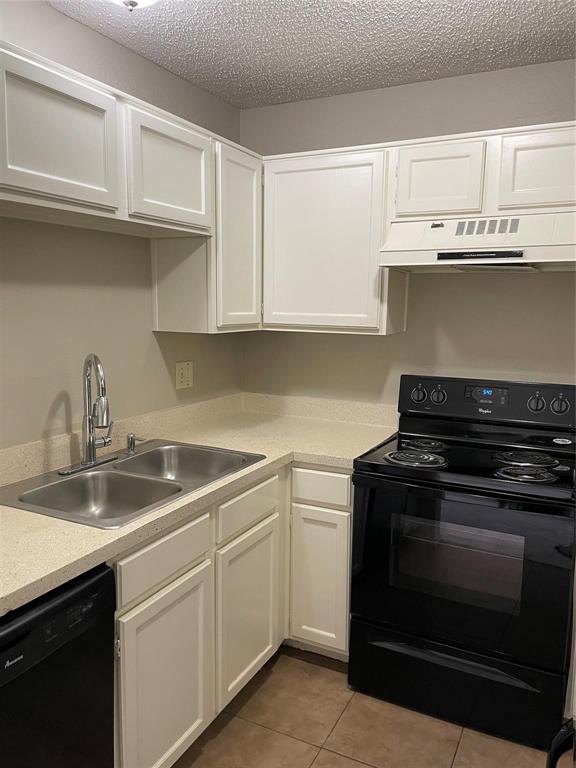 12 Trails Place, Unit AD Wylie, TX 75098 - Photo 21 of 40 a kitchen with granite countertop a stove sink and cabinets