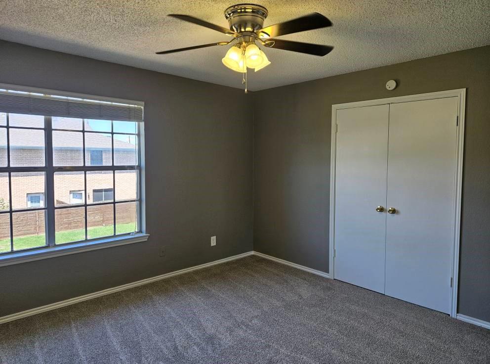 12 Trails Place, Unit AD Wylie, TX 75098 - Photo 3 of 40 a view of an empty room with window and chandelier fan