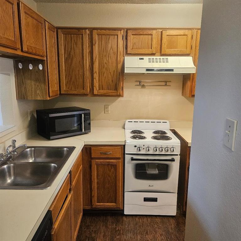 12 Trails Place, Unit AD Wylie, TX 75098 - Photo 32 of 40 a kitchen with granite countertop a sink a stove and cabinets