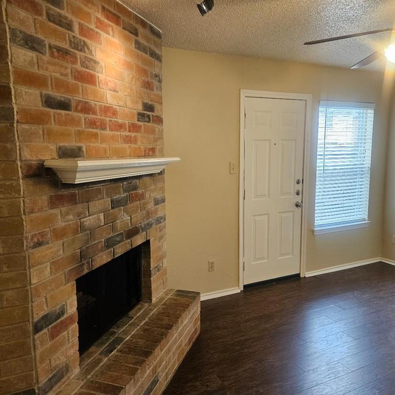 12 Trails Place, Unit AD Wylie, TX 75098 - Photo 36 of 40 a view of a livingroom with wooden floor and a fireplace