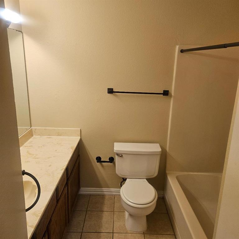 12 Trails Place, Unit AD Wylie, TX 75098 - Photo 38 of 40 a bathroom with a granite countertop toilet and a sink