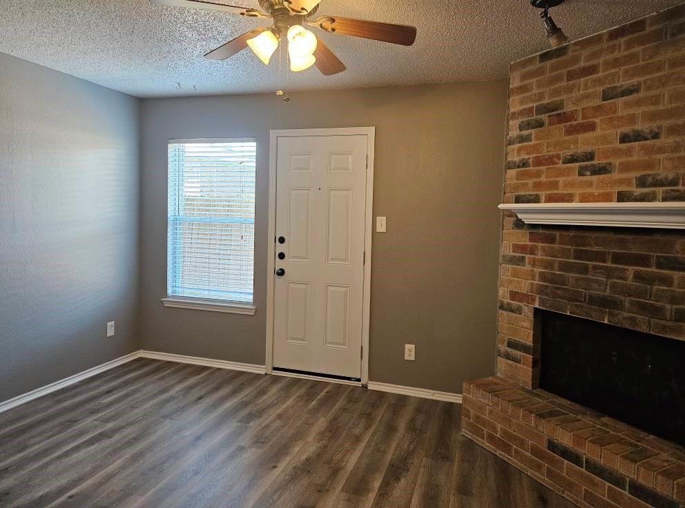 12 Trails Place, Unit AD Wylie, TX 75098 - Photo 4 of 40 an empty room with windows and fireplace