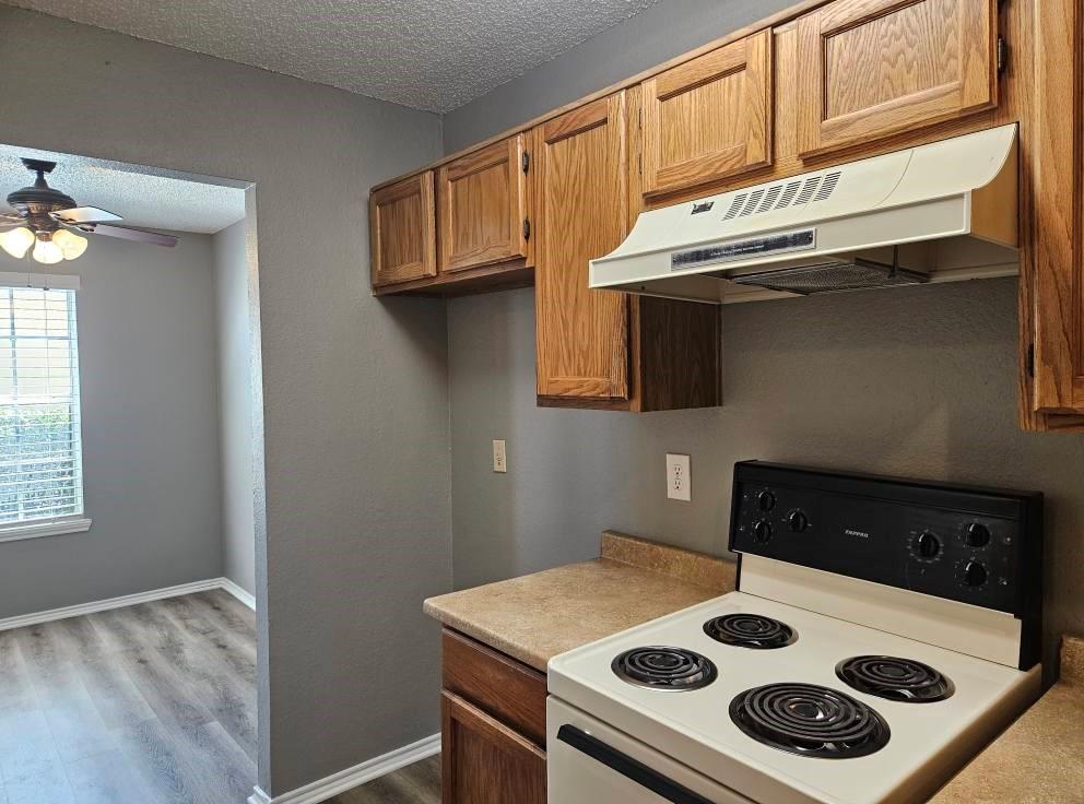 12 Trails Place, Unit AD Wylie, TX 75098 - Photo 6 of 40 a kitchen with a stove and a microwave