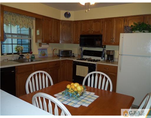 804 Maplecrest Road Edison, NJ 08820 - Photo 4 of 12 a kitchen with a stove a sink and a dining table