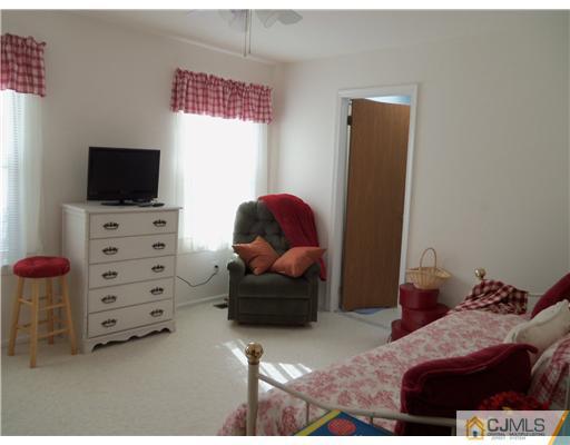 804 Maplecrest Road Edison, NJ 08820 - Photo 6 of 12 a bedroom with a bed and flat screen tv