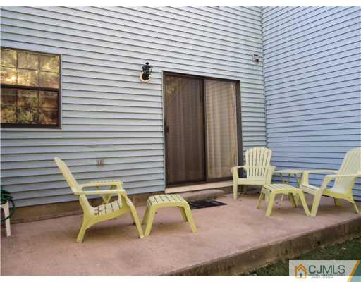804 Maplecrest Road Edison, NJ 08820 - Photo 9 of 12 a view of a patio with table and chairs and wooden fence