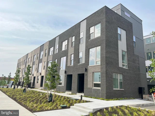 a front view of a building with a yard