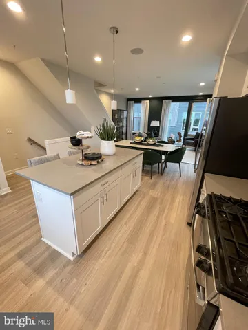 a view of a room with wooden floor and furniture
