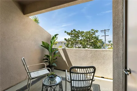 a view of a chairs and table in the balcony