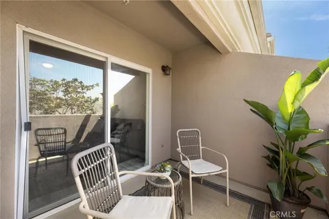 a view of a balcony with chair and potted plant