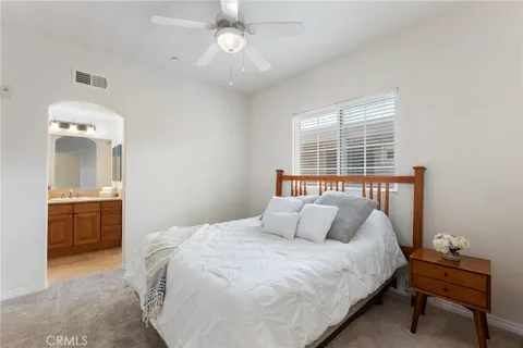 a bedroom with a large bed and a chandelier