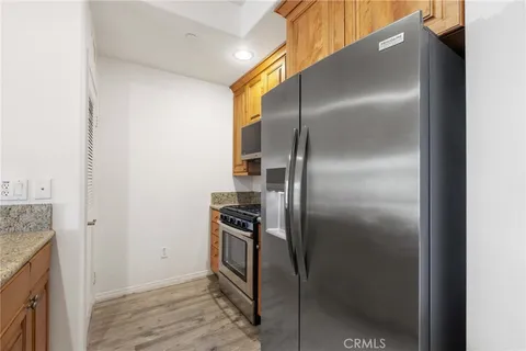 a kitchen with metallic refrigerator freezer and a sink