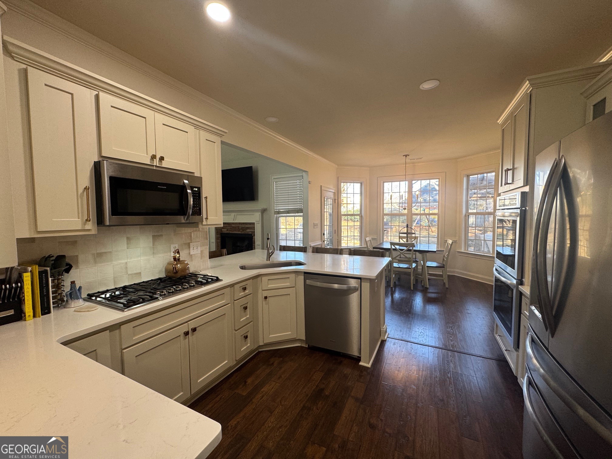 80 Middleton Trace Newnan, GA 30265 - Photo 11 of 30 a kitchen with stainless steel appliances a stove a sink dishwasher a microwave oven and a refrigerator with wooden floor