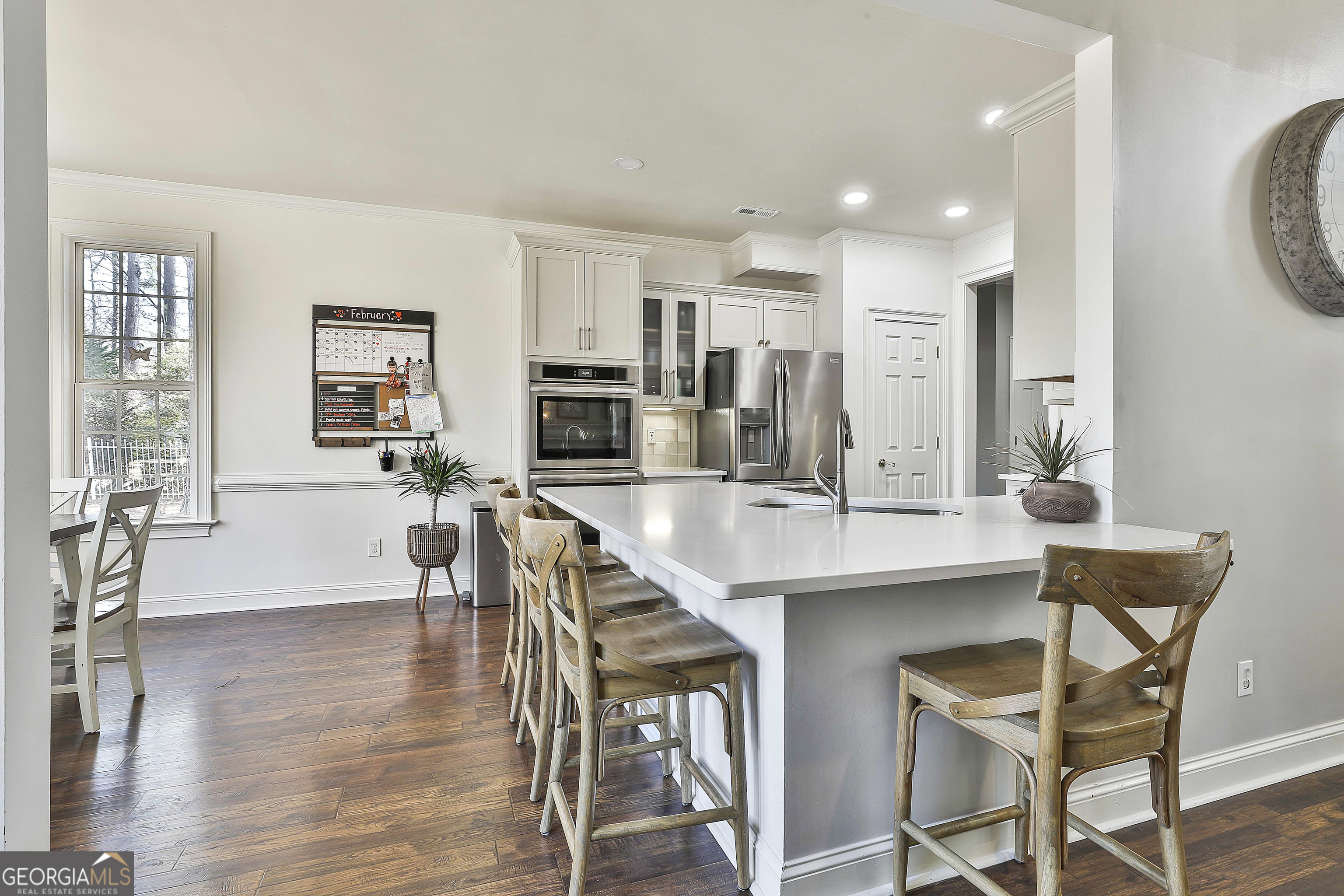 80 Middleton Trace Newnan, GA 30265 - Photo 23 of 92 a kitchen with stainless steel appliances kitchen island granite countertop a stove a sink a dining table and chairs
