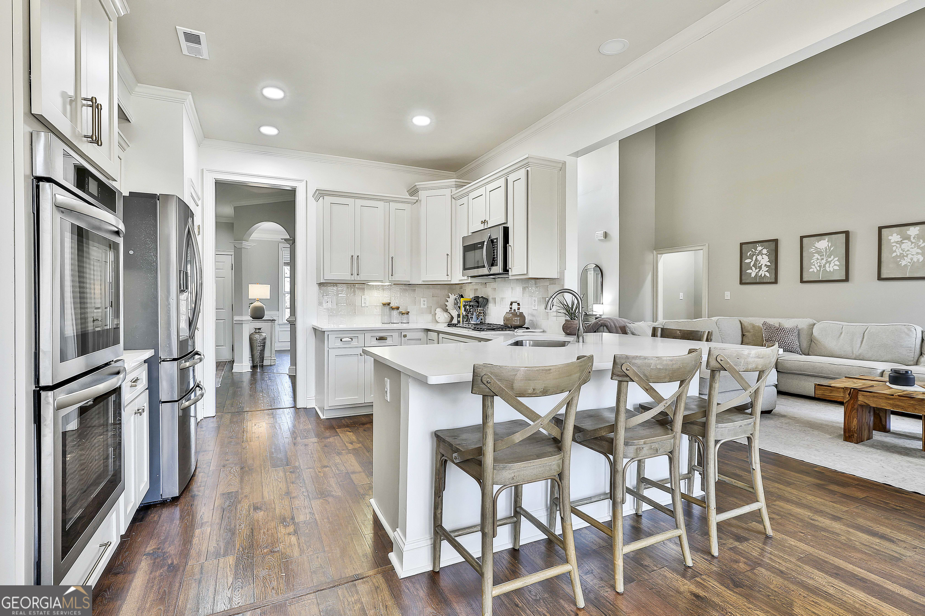 80 Middleton Trace Newnan, GA 30265 - Photo 26 of 92 a kitchen with stainless steel appliances kitchen island granite countertop a table chairs refrigerator and cabinets