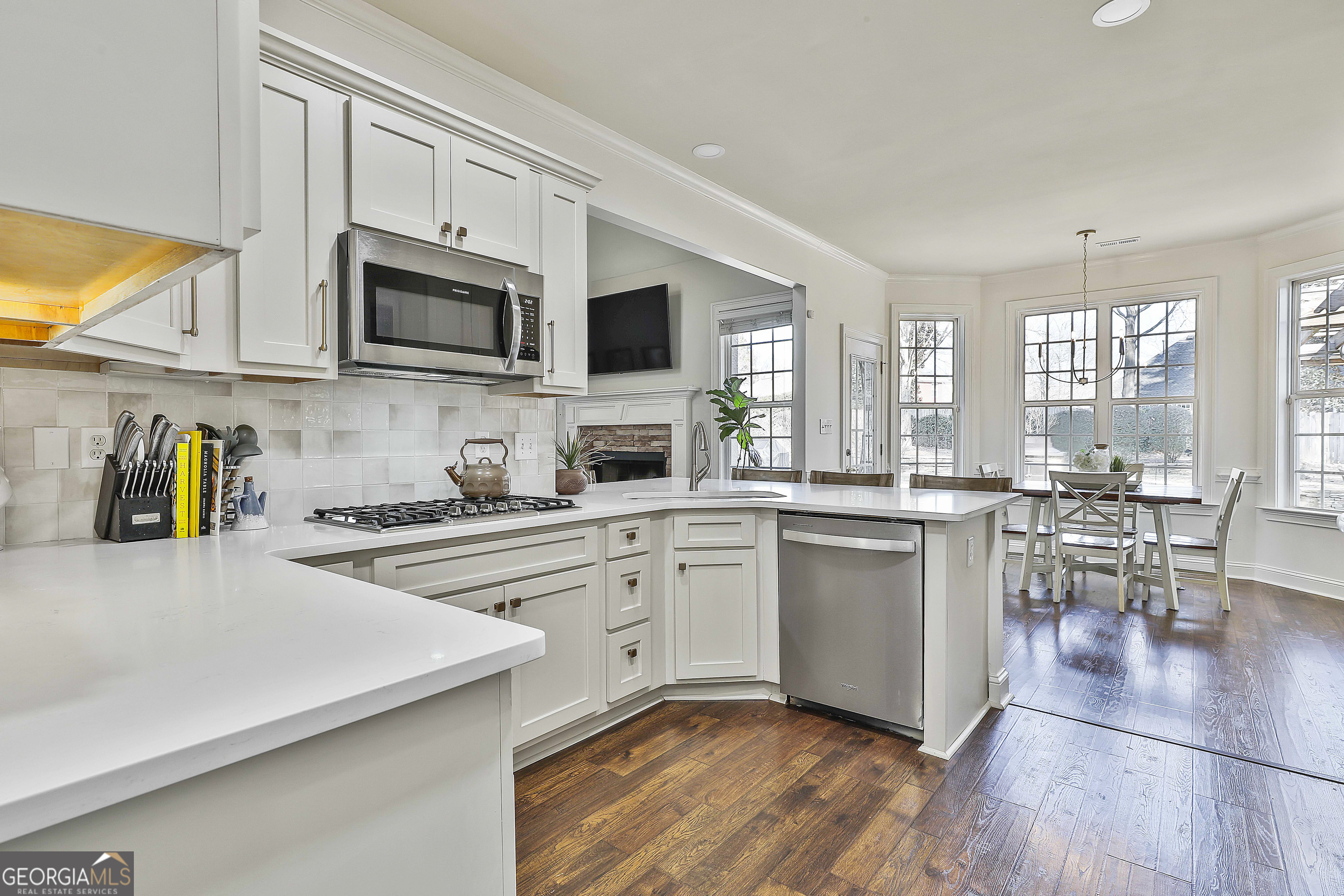 80 Middleton Trace Newnan, GA 30265 - Photo 28 of 92 a kitchen with stainless steel appliances granite countertop a stove a sink a microwave and white cabinets
