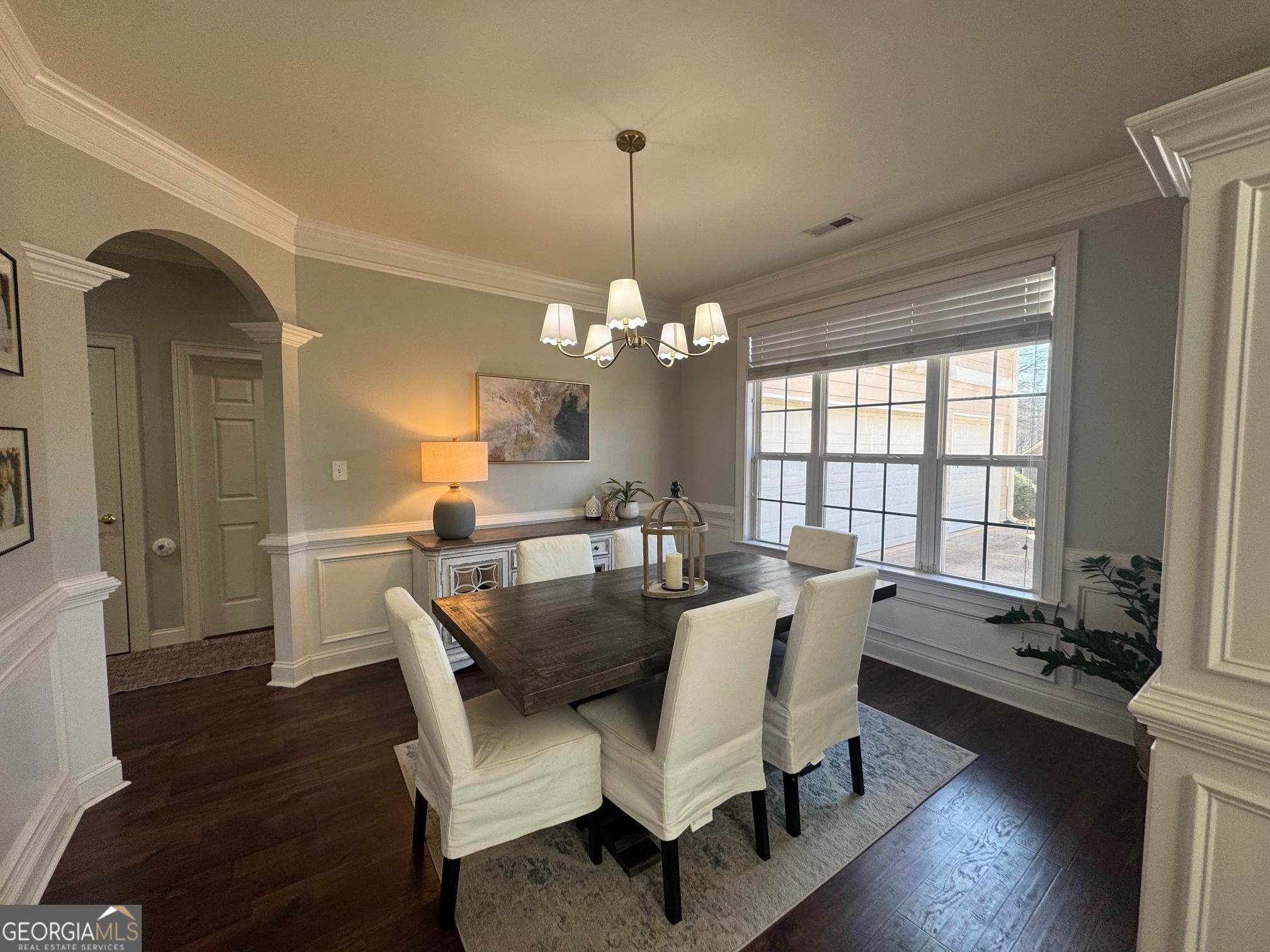 80 Middleton Trace Newnan, GA 30265 - Photo 4 of 30 a dining room with wooden floor a chandelier a wooden table and chairs