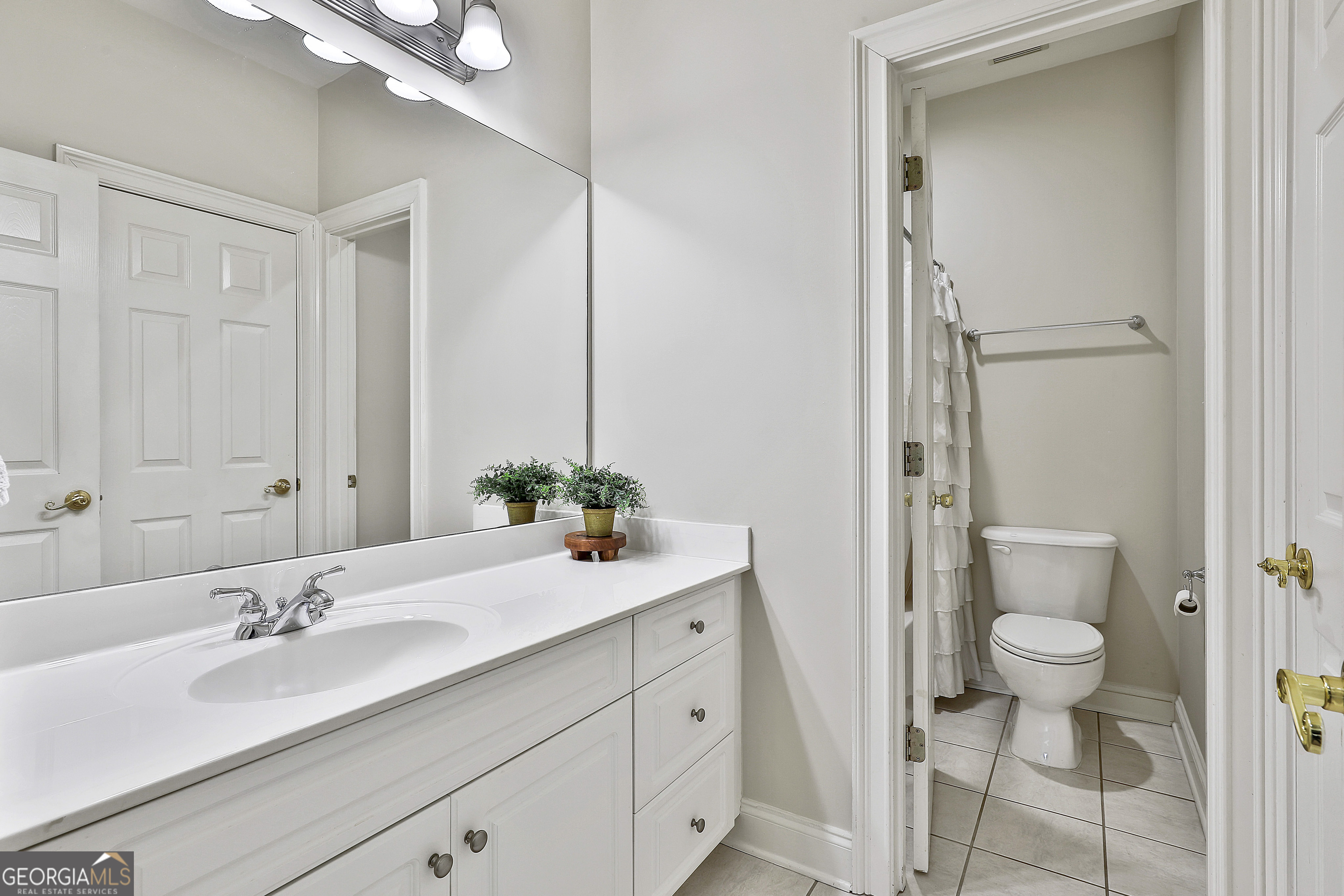 80 Middleton Trace Newnan, GA 30265 - Photo 44 of 92 a bathroom with a sink and a mirror