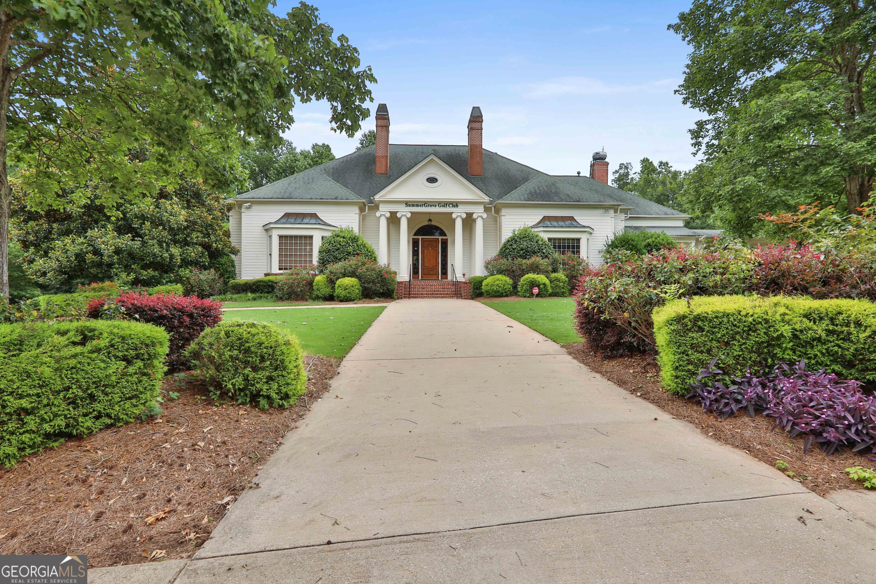 80 Middleton Trace Newnan, GA 30265 - Photo 85 of 92 a front view of a house with a yard and potted plants