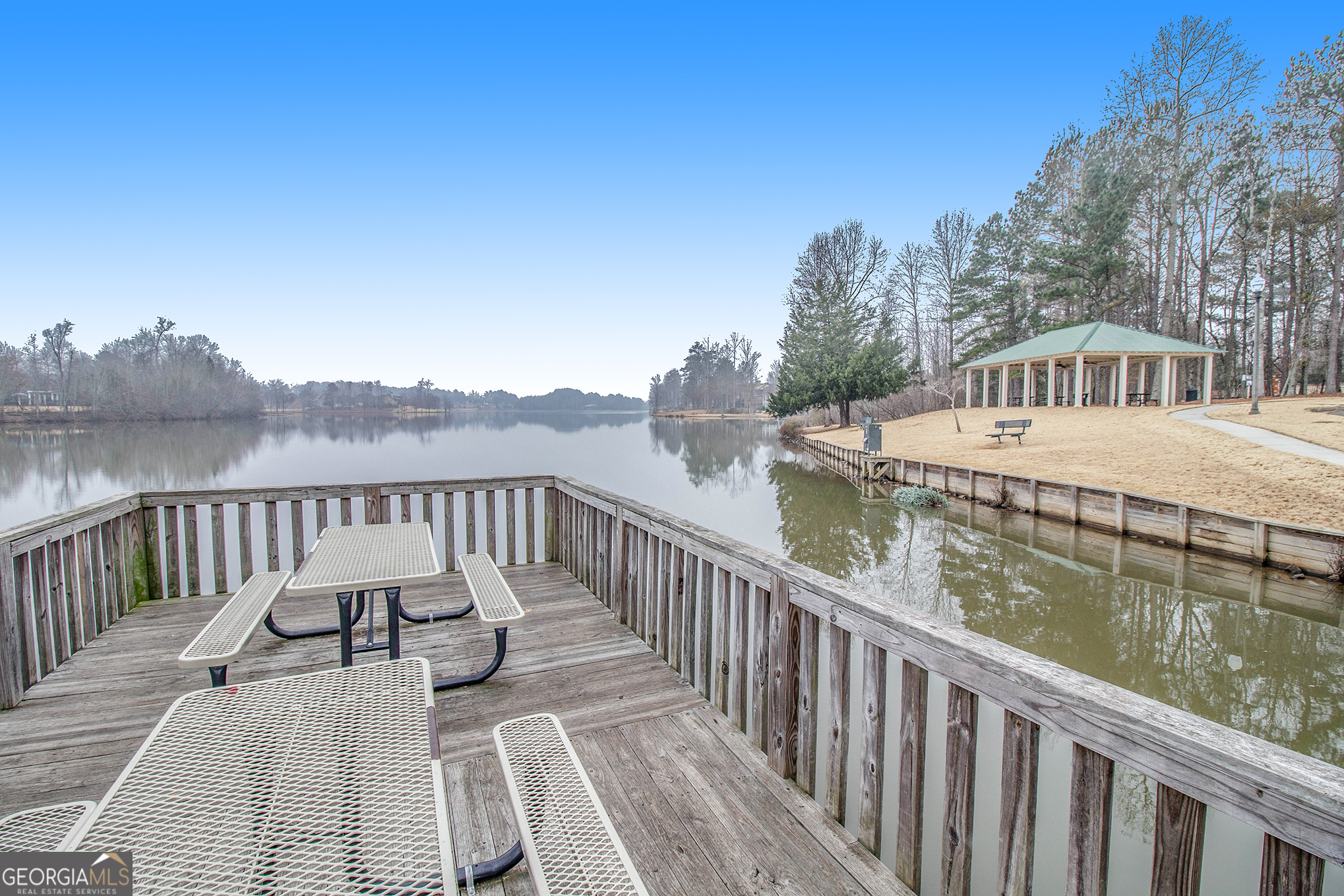 80 Middleton Trace Newnan, GA 30265 - Photo 89 of 92 a view of a wooden deck and lake with trees in the background