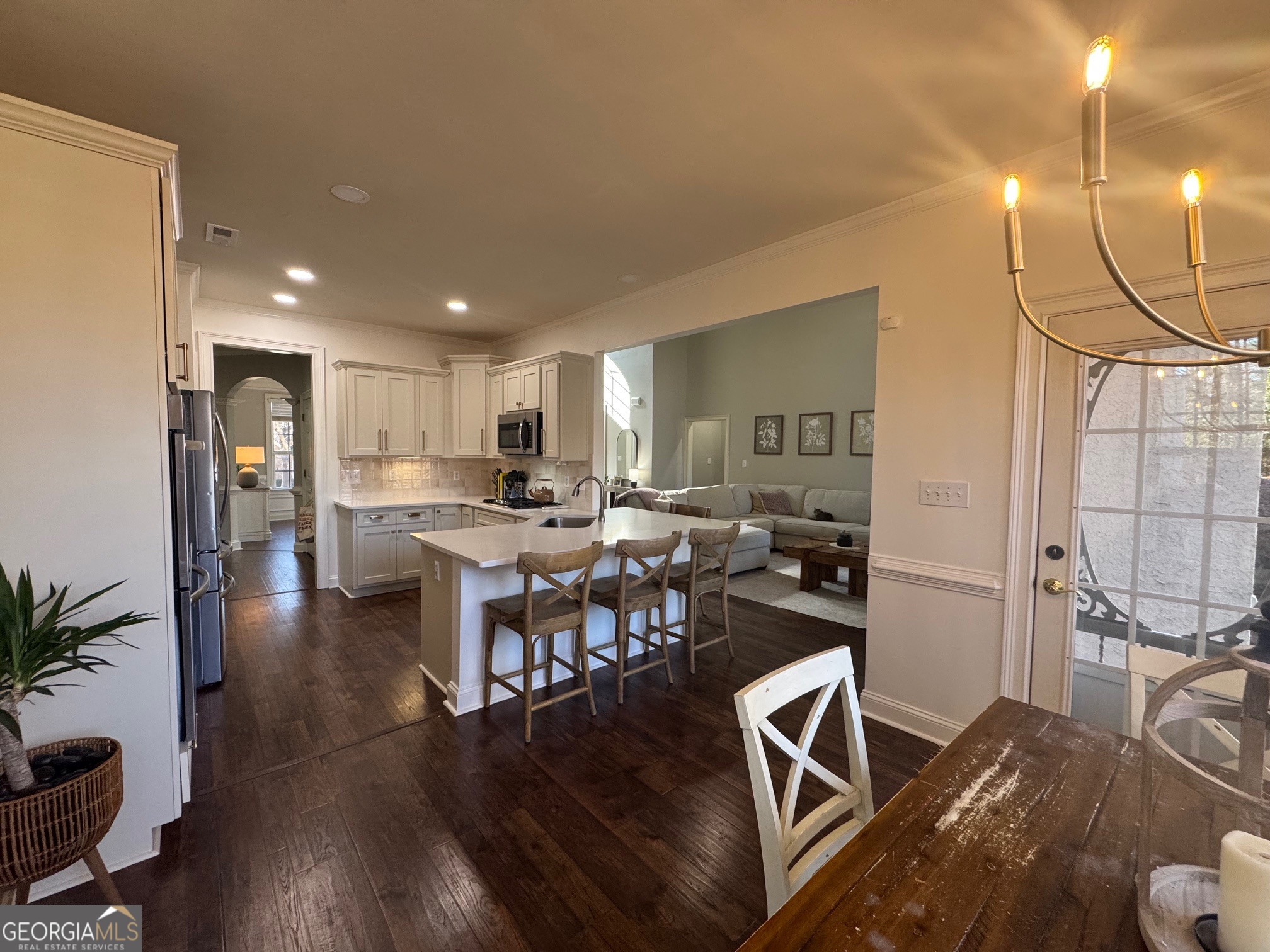 80 Middleton Trace Newnan, GA 30265 - Photo 9 of 30 a kitchen with stainless steel appliances kitchen island granite countertop a table chairs refrigerator and sink