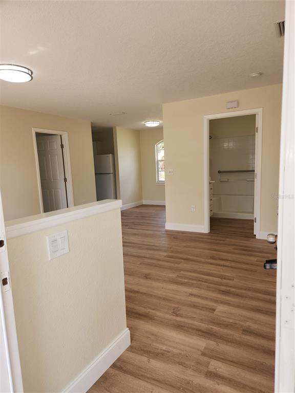 1652 Southwest Harlem Circle Arcadia, FL 34266 - Photo 5 of 17 a view of a hallway with wooden floor