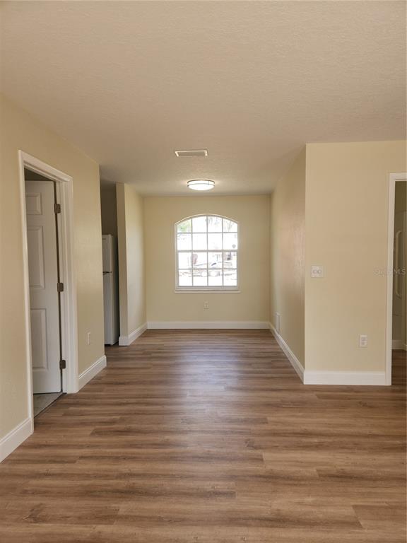 1652 Southwest Harlem Circle Arcadia, FL 34266 - Photo 6 of 17 a view of an empty room with wooden floor and a window