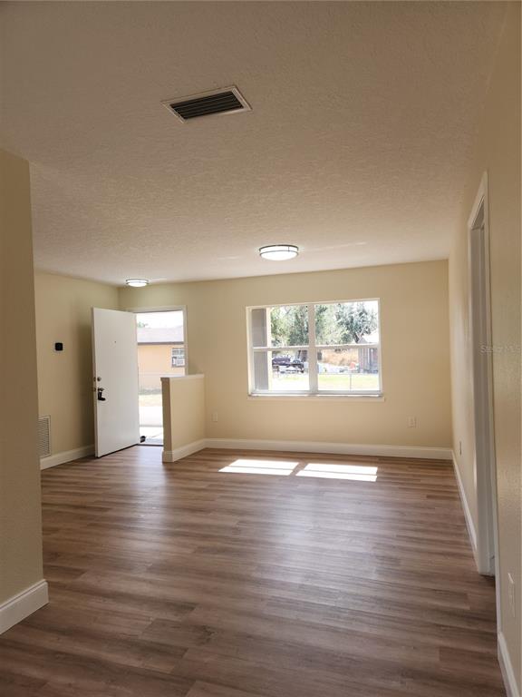 1652 Southwest Harlem Circle Arcadia, FL 34266 - Photo 7 of 17 a view of an empty room with window and wooden floor