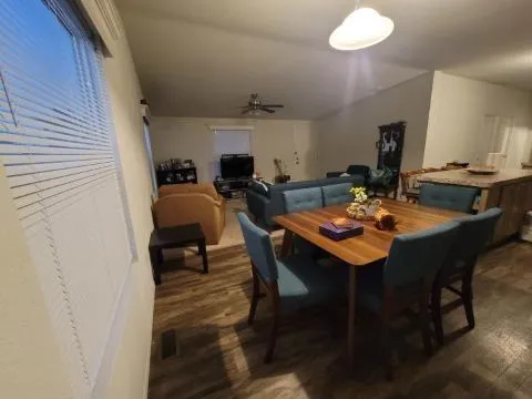 a view of a dining room with furniture and wooden floor