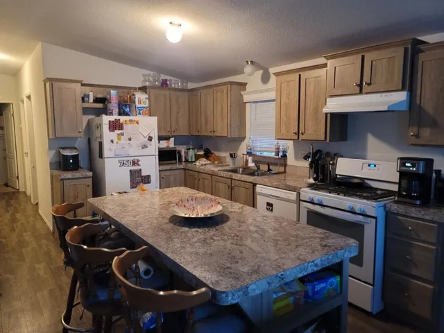 a kitchen with a table chairs stove and cabinets