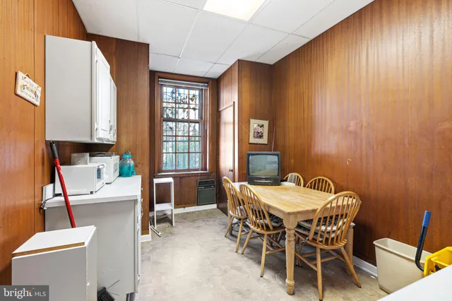 a view of a dining room with furniture and window