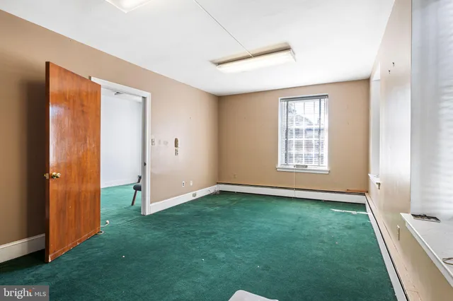 an empty room with windows and closet